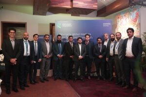 Standard Chartered Pakistan SME client engagement event in Lahore where bank officials discuss foreign exchange solutions with local business owners