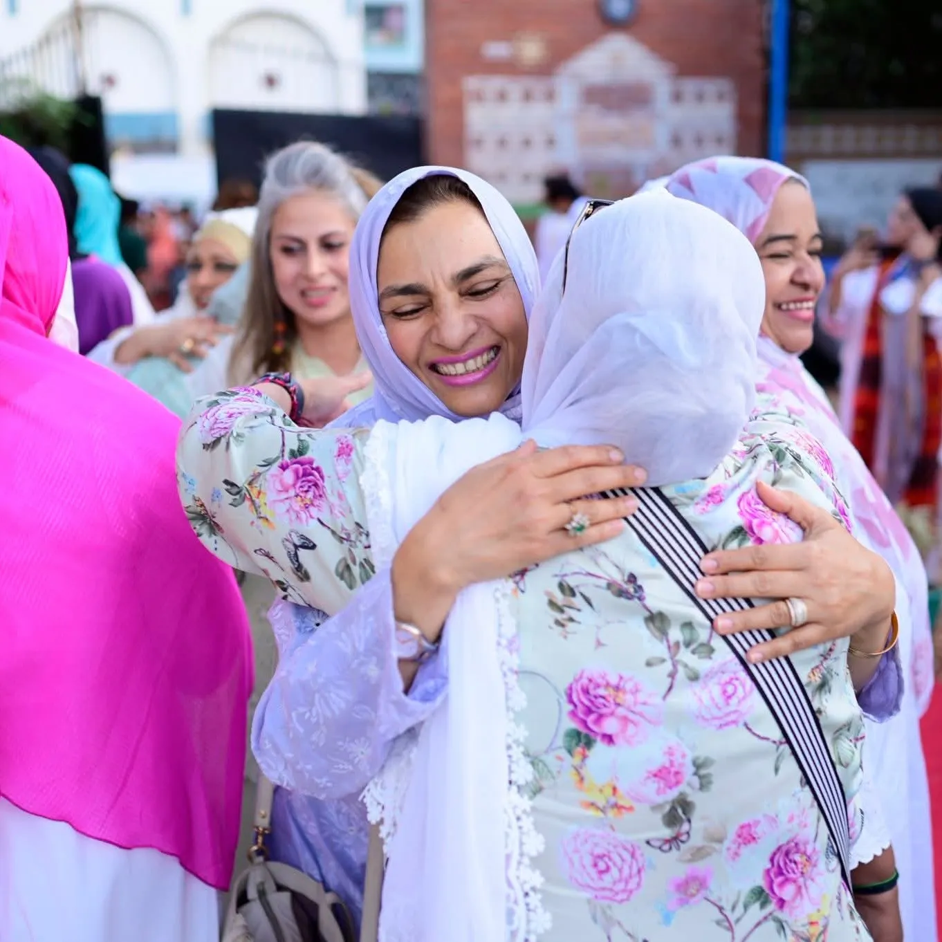 Sabina Khatri hugging guests and welcoming families at the Shafqat Bhara Iftar in Lyari.
