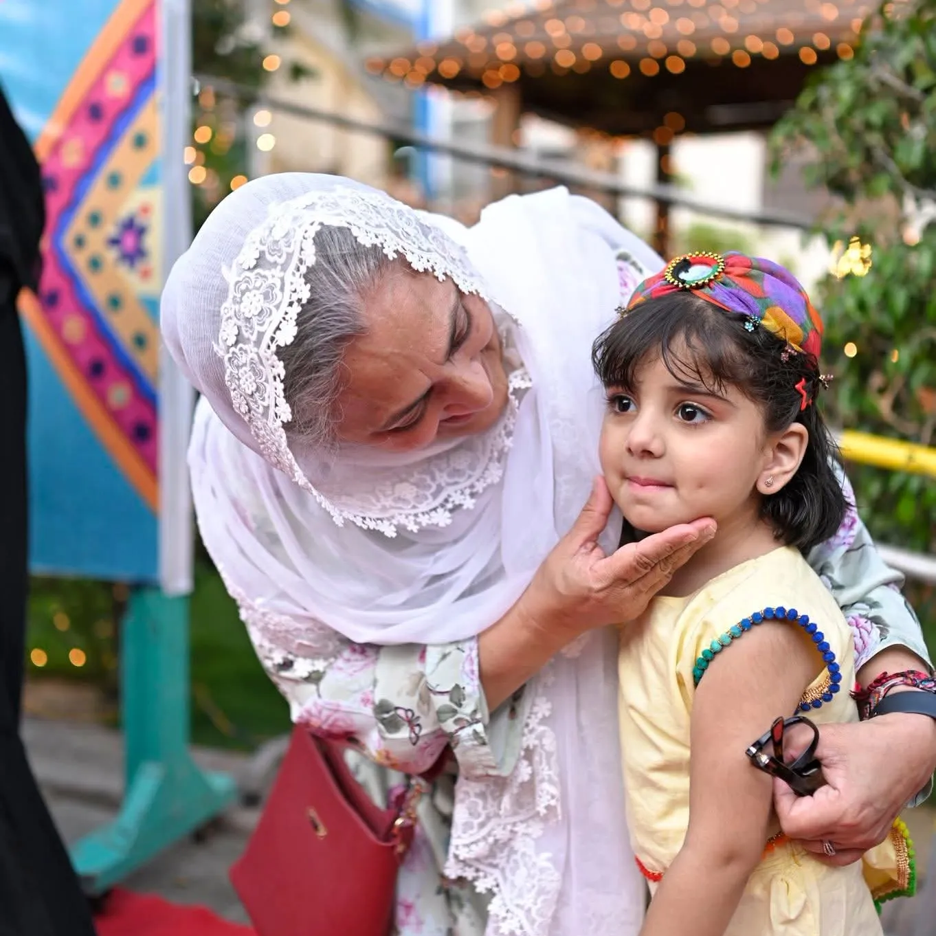 Sabina Khatri interacting with a young child at the Shafqat Bhara Iftar at Kiran Foundation Lyari