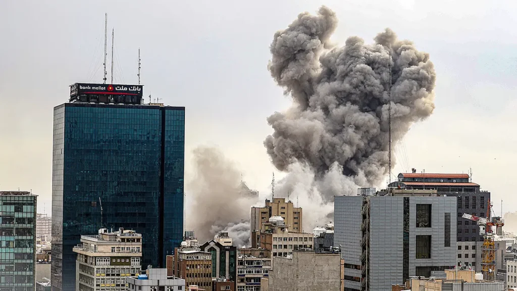 Smoke rises over Tehran after explosions were reported in the Iranian capital amid escalating regional conflict.